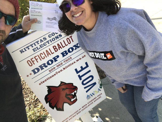 Head coach Chris Fisk (left) and his wife, drop off their ballots to set an example for athletes.