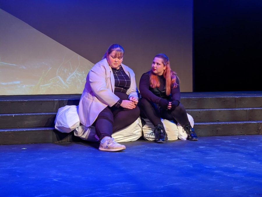 Jess Jones(left) as Olivia and Megan Walters as Anne sit on a dead body and chat. Photo by Mason Saulsbury. 